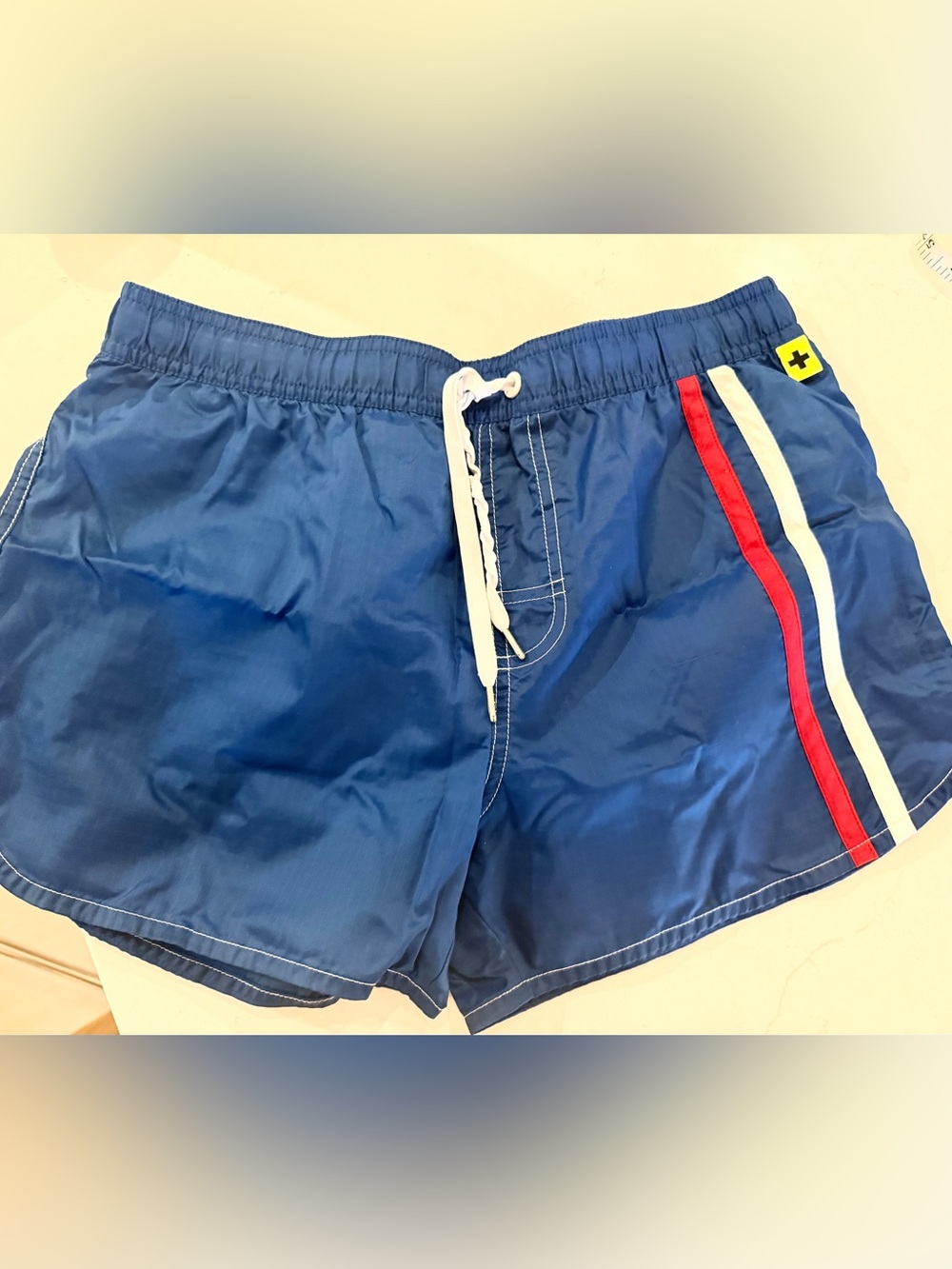 Andrew Christian Navy Swim Trunks with Red and White Side Stripes